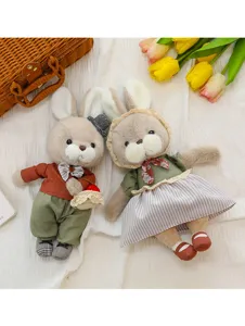Detailed view of cute plush rabbit couple dolls with exquisite clothing and props.