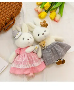 Detailed view of couple rabbit plush toys wearing delicate pink and plaid dresses