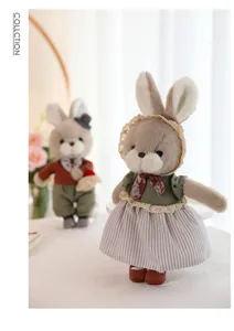 Adorable handmade plush couple rabbit dolls wearing vintage lace outfits on a table