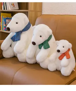 A group of three cute white polar bear plush toys in various sizes wearing vibrant scarves.