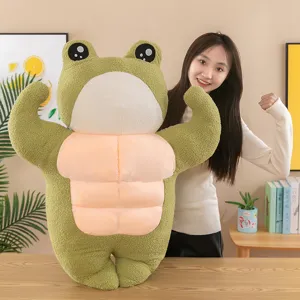 Adorable green muscular frog plush toy shown with a model in a cozy lifestyle setting