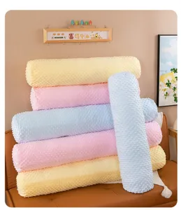 Soft minky dot long bolster pillows in pastel colors stacked for comfortable sleep support.
