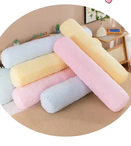 Soft minky dot cylindrical long bolster pillows in pastel pink, yellow and blue.