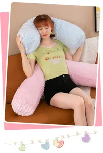 Soft minky dot body pillow used as back support and hug cushion by a model on a sofa