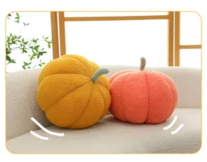 Dekorative Kürbis-Plüschkissen mit Bouclé-Textur auf einem cremefarbenen Stoffsofa