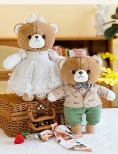 Vista detallada de dos lindos ositos de peluche vestidos sobre una maleta vintage
