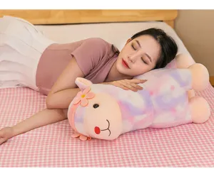 Asian model hugging a colorful rainbow alpaca plush pillow in a cozy bedroom setting