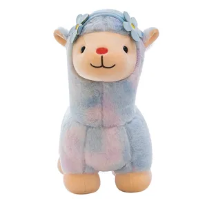 Cute rainbow alpaca plush toy with blue floral headband on white background