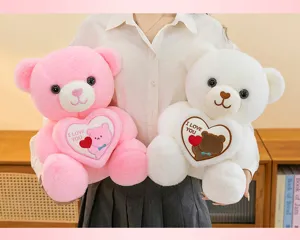 Details of pink and white plush teddy bears holding hearts with I Love You embroidery