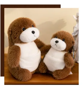 Detailed view of two simulation sea otter plush toys in different sizes on wooden shelf.
