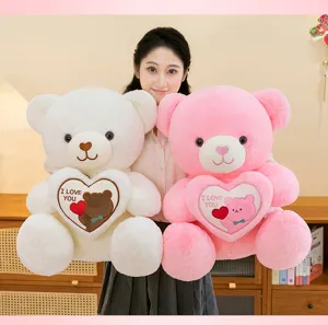Large soft plush teddy bears in pink and white holding hearts for Valentine's gifts