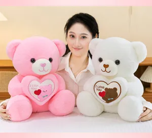 Detailed view of pink and white plush bears holding embroidered I Love You hearts