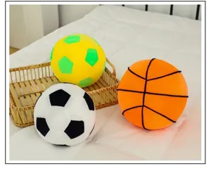Three plush sports ball pillows including soccer and basketball designs