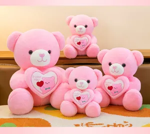 Four pink plush teddy bears in various sizes holding white hearts with I LOVE YOU text