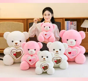Plush teddy bears in pink and white holding hearts with I Love You text for gifts