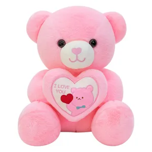 Pink plush teddy bear holding a heart with I LOVE YOU embroidery for Valentine's Day