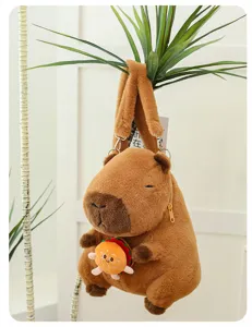 Adorable capybara plush backpack holding a small hamburger, hanging on a green plant.