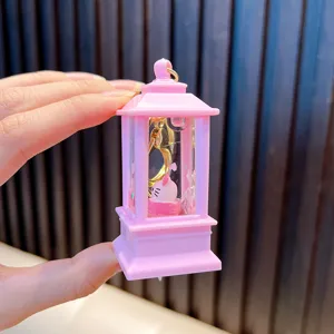 Detail view of a pink lantern-shaped liquid quicksand keychain with a cute kitty