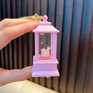 Close-up of a pink lantern keychain with liquid quicksand and a cute rabbit figure.