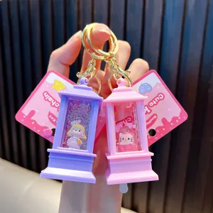 Close-up of cute pink and purple quicksand oil keychains with liquid glitter