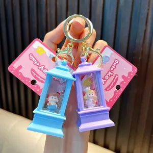 Close-up of lighthouse-shaped liquid sand keychain with glitter and cute girl figurine