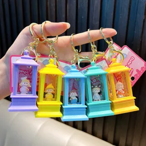 Detail of five colorful lantern-shaped liquid sand keychains with cute rabbit doll inserts.