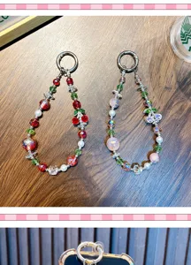 Detailed view of handmade cherry beaded phone charms with red and pink sparkling crystal beads.
