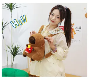 Close-up of cute brown capybara plush backpack worn by an Asian model in cozy room