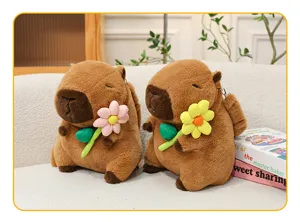 Detailed view of cute plush capybara backpacks holding colorful fabric flowers on a couch.