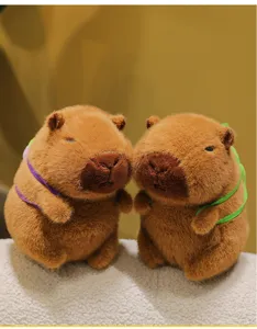 Detail view of cute capybara plush toys with soft fluffy texture and colorful straps