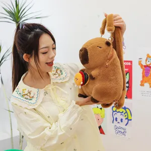 Adorable brown plush capybara backpack with small burger toy accessory held by model