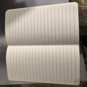 Detail view showing the internal lined cream pages of an A5 vintage stitched notebook