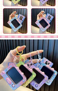 A close-up view of multiple colorful piggy mini drawing board keychains held in hand