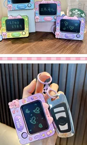 Mini pig-themed drawing board keychain held with a car key to show compact size scale
