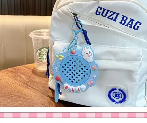 Detail shot of a blue rabbit magnetic drawing board keychain hanging on a white backpack