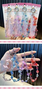 Colorful acrylic flower beaded phone chain detail, cute charm strap for bags and mobile cases.