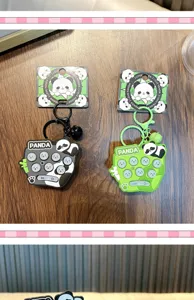 Detail of cute panda electronic whack-a-mole keychain toy with functional buttons