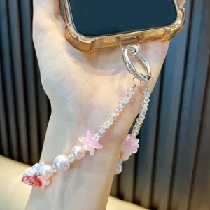 Elegant handmade beaded phone charm featuring pink flowers and pearls wrist strap
