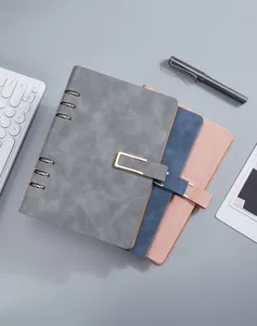 Close-up detail view of colorful A5 loose-leaf leather notebooks with 6-ring binders and clasps