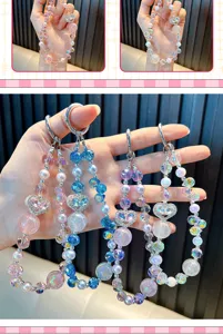 Close-up detail of colorful heart crystal beaded keychains used as bag charms and pendants
