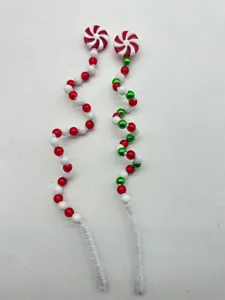 Close-up of red and green beaded Christmas picks with peppermint windwheel toppers