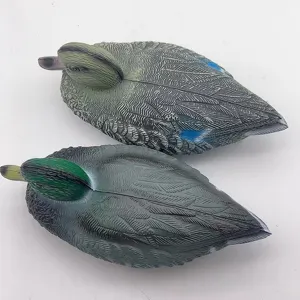 Realistic plastic duck decoys for garden decoration showing detailed feather texture.