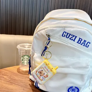 Mini electric phone maze game keychain with cute capybara design on white backpack