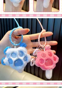 Detailed view of soft plush cat paw keychains in blue and pink as cute bag charms accessories.