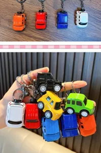 Detailed view of colorful alloy pull-back car model keychains in various colors