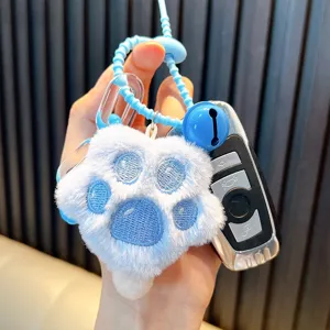 Cute blue plush cat paw keychain featuring a bell charm and stylish lanyard for bags.