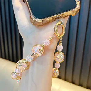 Dragonne de téléphone artisanale en perles roses avec breloques étoiles dorées pour femmes