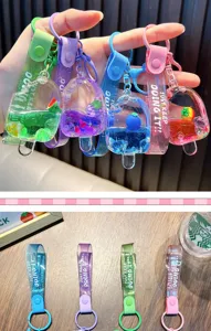 Detailed view of colorful popsicle keychains with floating fruit charms and liquid
