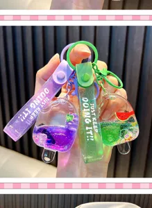 Close-up of vibrant fruit popsicle liquid quicksand keychains in purple and green