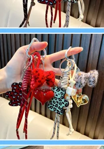 Detailed view of leopard print bear keychains with plush bows and heart charms